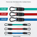 Set of resistance bands with carabiners in various weights on a white background