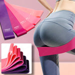 Resistance bands in purple, pink, and red shown alongside a model wearing gray leggings with a pink band around the hip, plus a folded product inset showing the bands.
